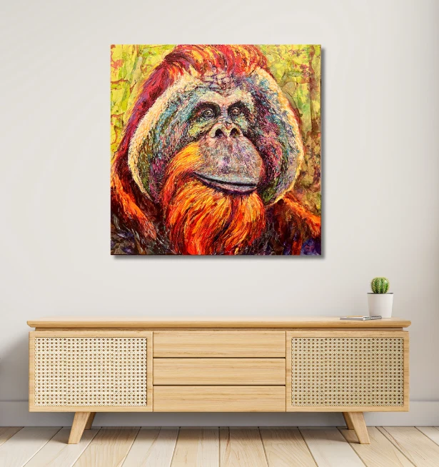 Colourful orangutan portrait painting displayed on a modern interior wall above a wooden console.